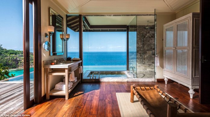 Four Seasons Seychelles' Serenity Villa has a deep-soaking tub enclosed with glass walls