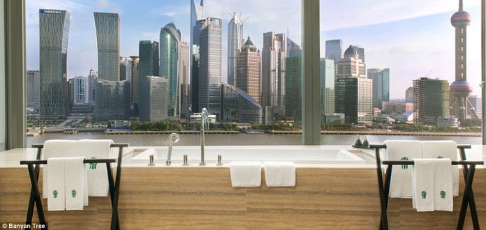 The Banyan Tree Shanghai Panorama Oasis suite has a huge bathtub in the room, with a view across the Huangpu River to the skyline