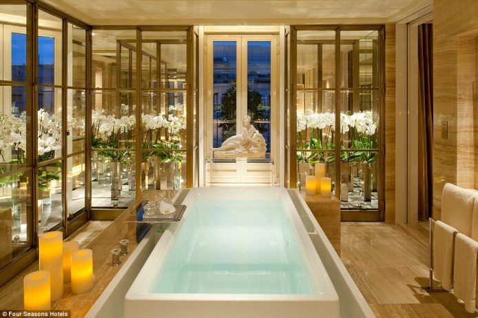 The glamorous £15,229 per night Penthouse suite bathroom at the Four Seasons Hotel George V in Paris features a beautiful infinity-edge bath filled with jets