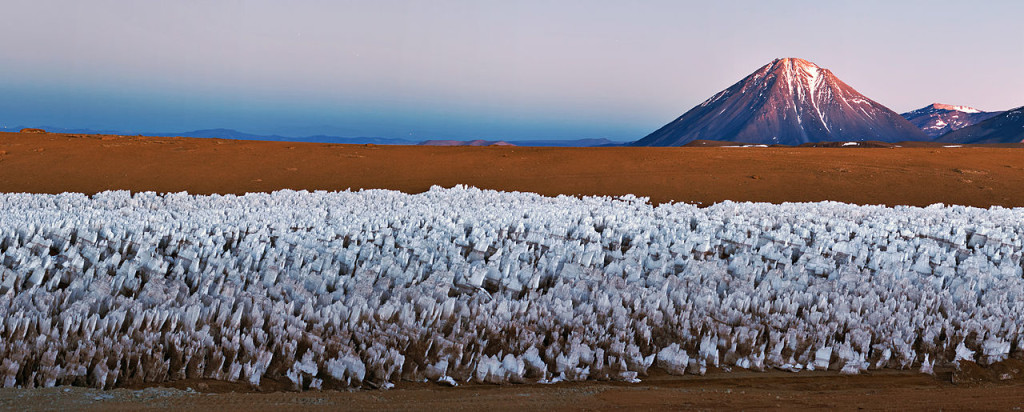 An icy forest of penitentes cluster in the foreground