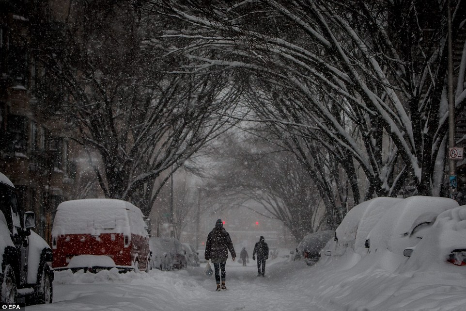 People walk through the streets of the Williamsburg section of Brooklyn, New York, on Saturday during the blizzard