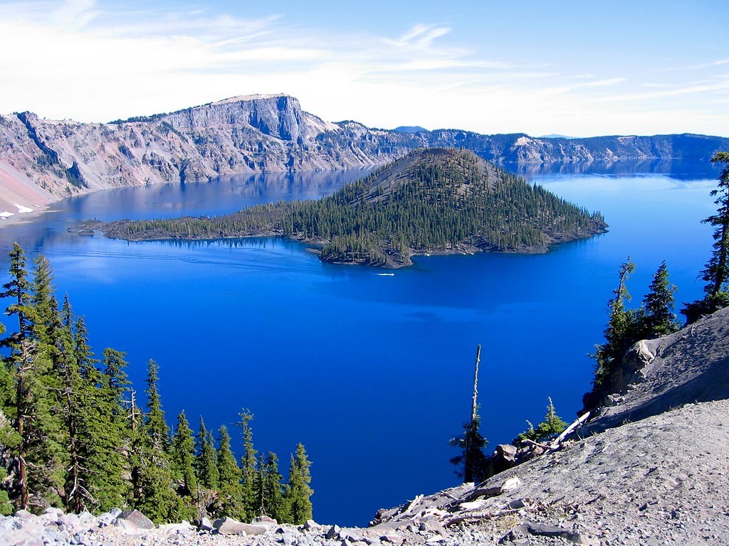 The Crater Lake is five to six miles across with a caldera rim ranging in elevation about 7,000 to 8,000 feet with average depth is 1,148 feet, while maximum measured depth is 1,949 feet. 