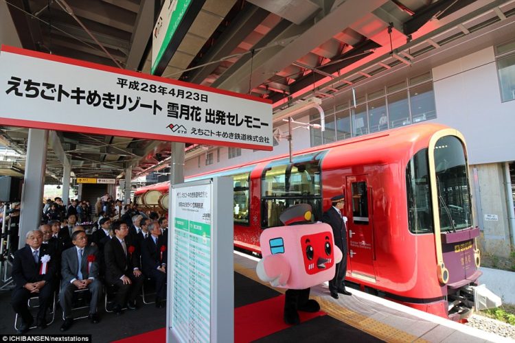 Selected guests wait to board the futuristic train, with a special cartoon character train conductor in attendance