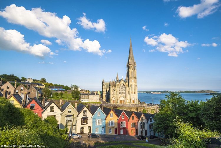 The coloured houses of Cobh (above), County Cork, Republic of Ireland, sit in a row facing perpendicular to the dramatic Irish coast