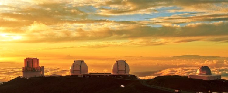 Peeking above the clouds, this is Hawaii's astronomical observatory on Mount Mauna Kea, a dormant volcano which is one of the best places on Earth