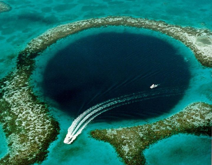 The Great Blue Hole a large submarine sinkhole off the coast of Belize, over 300m across and 124m deep.