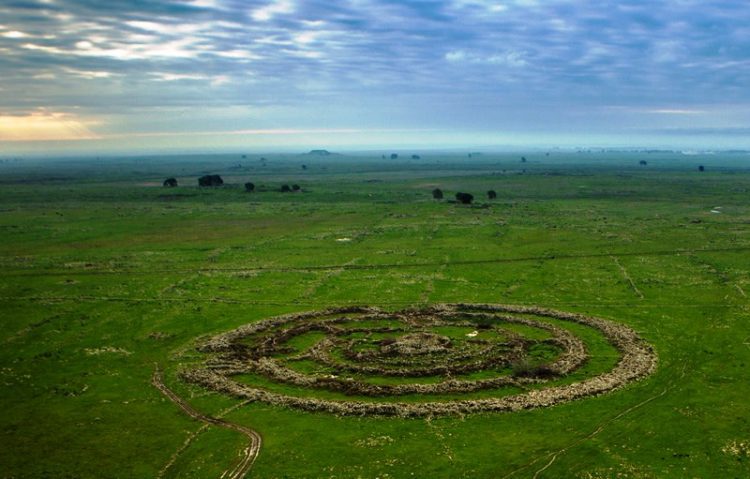 This is also called Rujm el-Hiri (means "stone heap of the wild cat) is dated to about 3000 BC, which makes it contemporary to famous England's Stonehenge. 