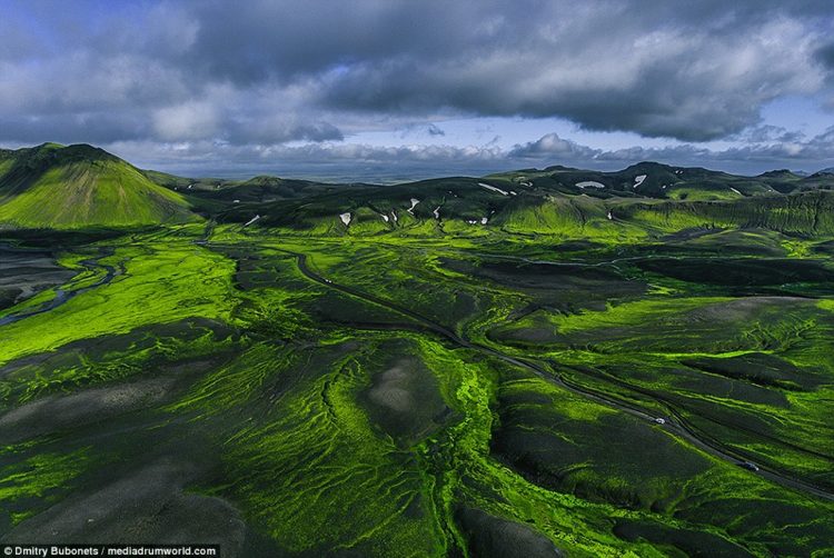 This incredible image shows the contrast of the ash-grey volcanic land against the lush green countryside