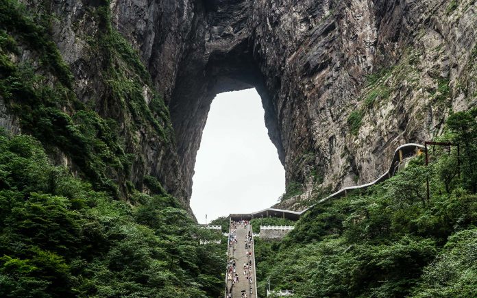 China Heaven Gate in Hunan province is named after an unbelievable cave natural arch eroded through the karst syncline.