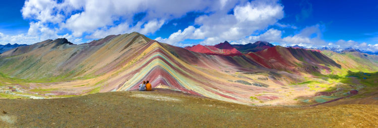 The mountain is striped with colors ranging from turquoise to lavender to maroon and gold. 