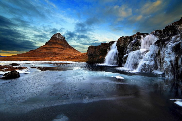 The mountain of Kirkjufell and its waterfall Kirkjufellsfoss, attracts nature lovers and photographers. 