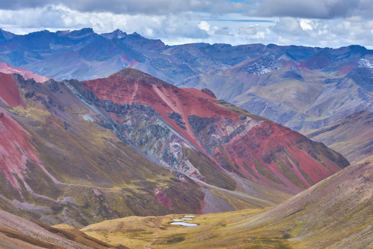 Rainbow Mountain is a colorful mountainside in the Andes of Peru. In short, the colors you see were formed by sedimentary mineral layers in the mountain that have been exposed by erosion.