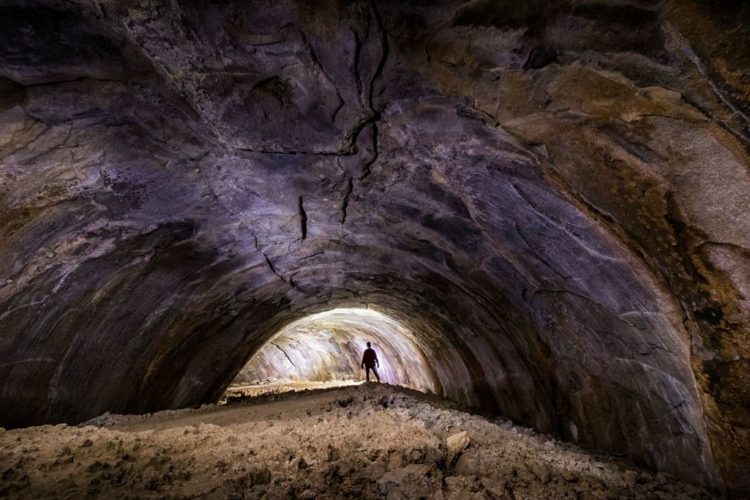 The Coconino Lava River Cave in the Coconino National Forest, near Flagstaff, Arizona is huge big enough for an individual to walk through with dozens of feet overhead.