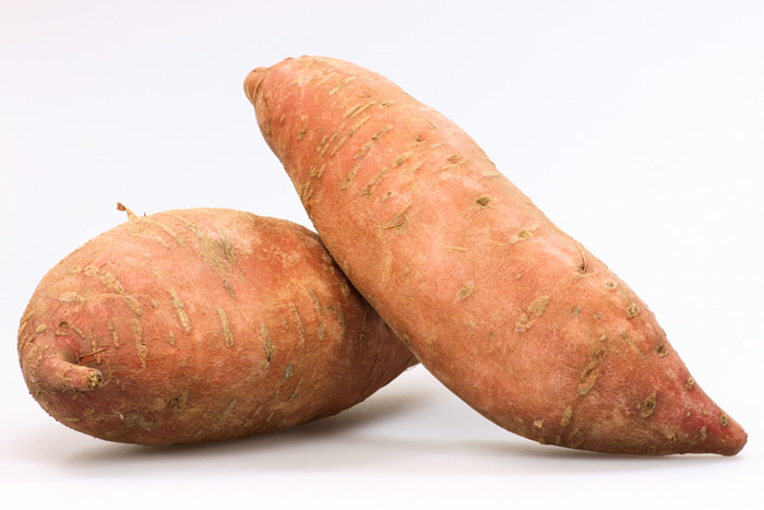 Sweet potatoes are tubers that grow under the ground just as white potatoes do, but there the resemblance ends.