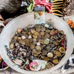 Visitors leave coins and trinkets at several of the doll shrines found inside some of the Island's buildings