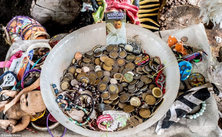 Visitors leave coins and trinkets at several of the doll shrines found inside some of the Island's buildings