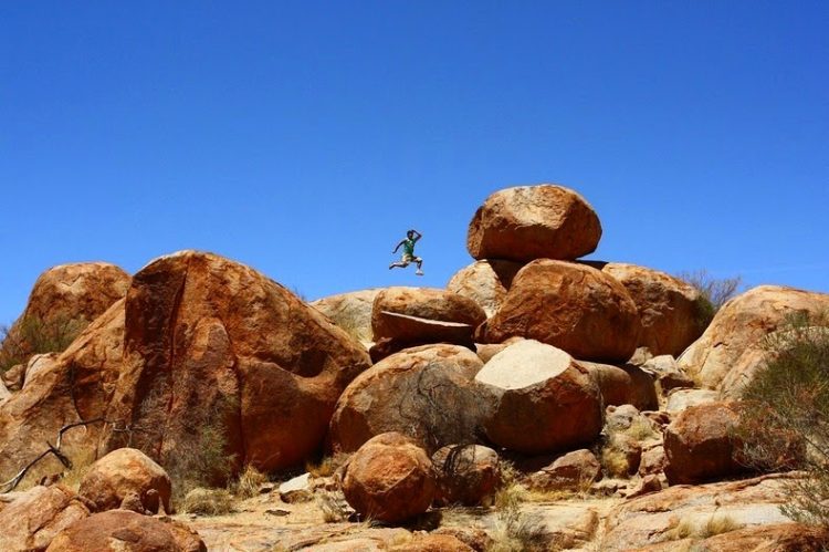 Different boulders are naturally precariously balanced atop one another or on massive rock formation.