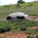 Bunkers in Albania domed concrete roofs and narrow eye slits crouched suggestively on either side of the road to Tirana.