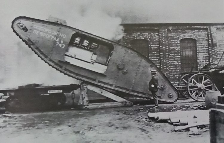 Armoured Cars and Tanks - Tank 743, a male being loaded a railway wagon for its factory. Either Fosters of its Lincoln or the Metropolitan Carriage and Finance Co at Wednesbury. The Russian lettering added to dispel rumors read with care to Petrograd. The Sponsons which housed the guns have been removed for transportation. This tank took part in the first tank attack as D18 with the 41st Division at Delville Wood.