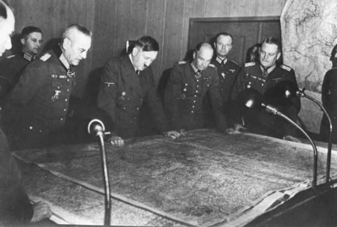 Hitler and his generals ponder wartime strategy.