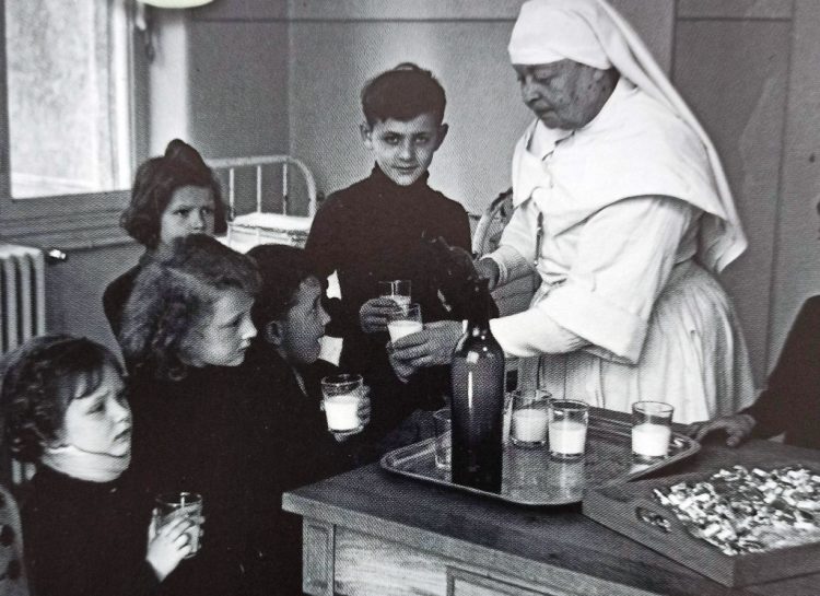 A nurse distributing vitamin supplements to children in a hospital in the south of France in 1941.