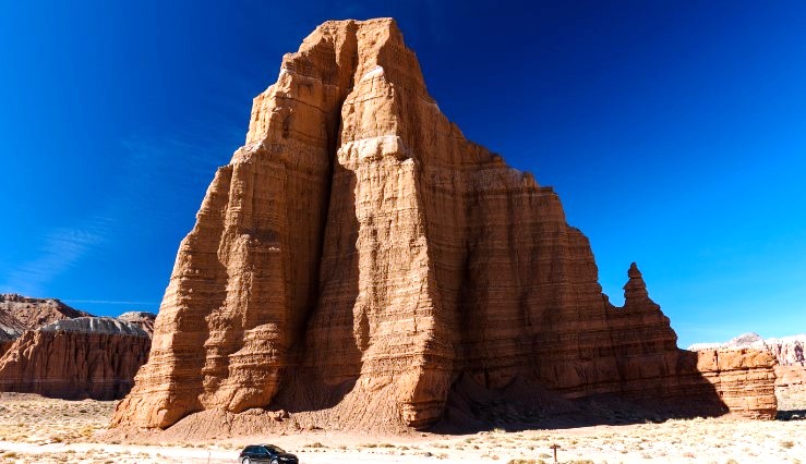 The Temple of the Sun is a monolith that towers over 400 feet above the surrounding terrain, which is part of the Fremont River drainage basin.