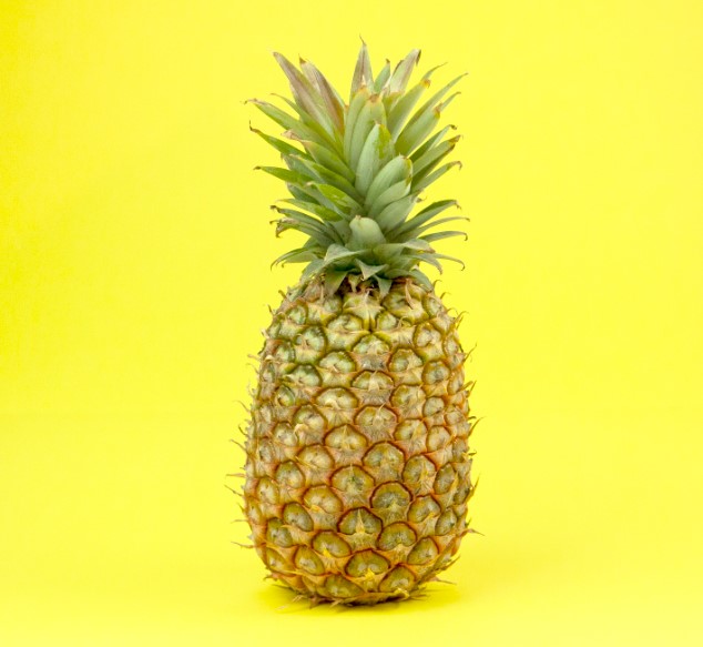 Pineapples are a tropical fruit that grows on a plant of the same name. The fruit is large, spiky, and has a tough, waxy skin that is usually a dark greenish-brown or yellowish-brown color.