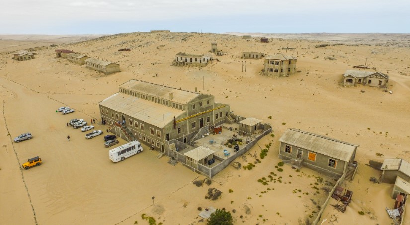 The ghost town of Kolmanskop lies in the Namib Desert of Namibia, approximately 10 kilometers inland from Lüderitz