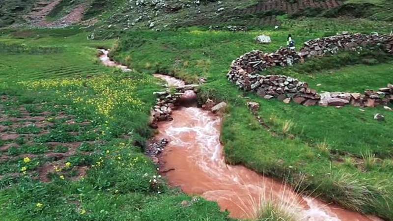 Red sandstone in the region contains iron oxide, which gives the Red River its crimson color.