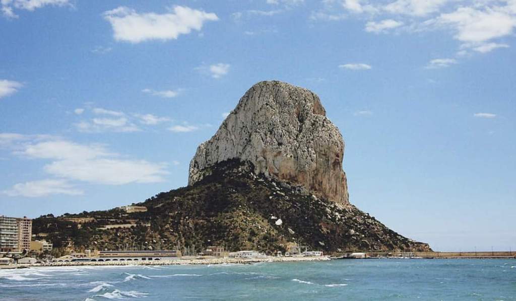 Penyal d'Ifac or Calpe rock is an outcropping of limestone extending from the sea and connected to the shore by rock debris in Spain.