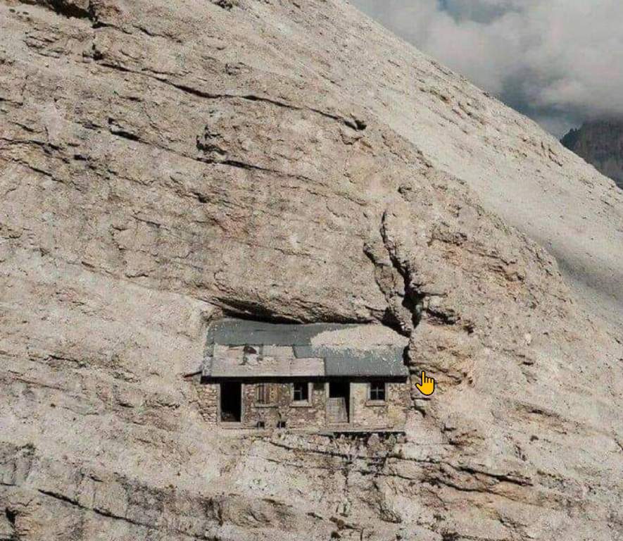 An alpine embedded from World War I tucked up on the sheer face of a Dolomite Mountain in Italy.