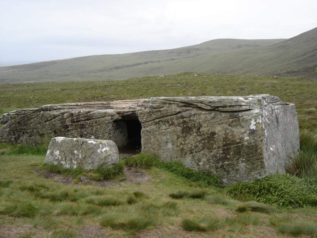 The Dwarfie Stane is a megalithic chambered tomb formed out of a massive block of Devonian Old Red Sandstone.