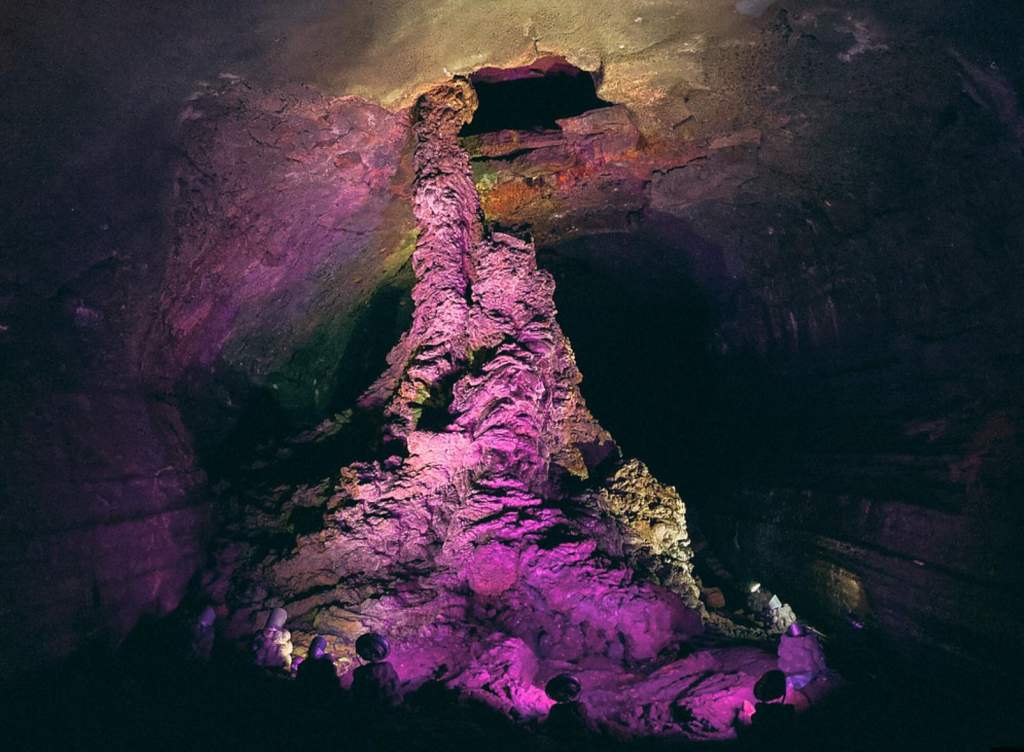 For tourist attractions, Manjanggul cave rocks are illuminated by multicolored lights, creating a spooky atmosphere in the cave.